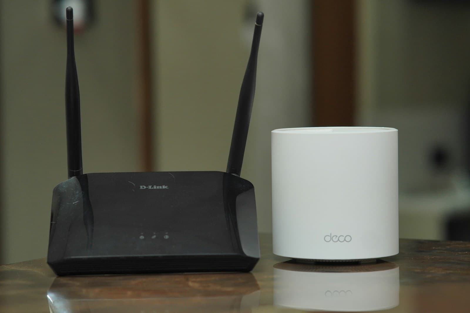 Two home Wi-Fi routers positioned side by side for comparison