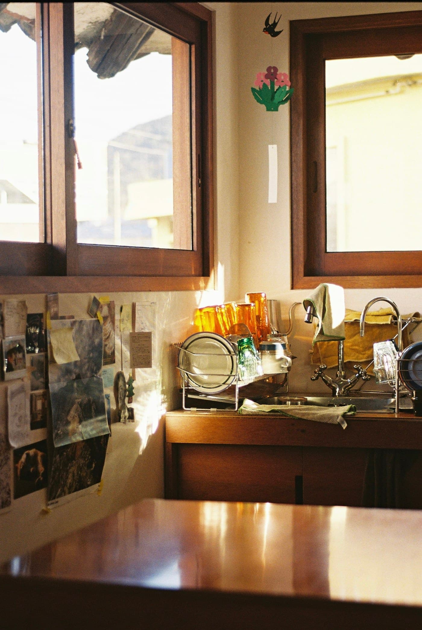 Sunlit kitchen with wood cabinets and a central worktable