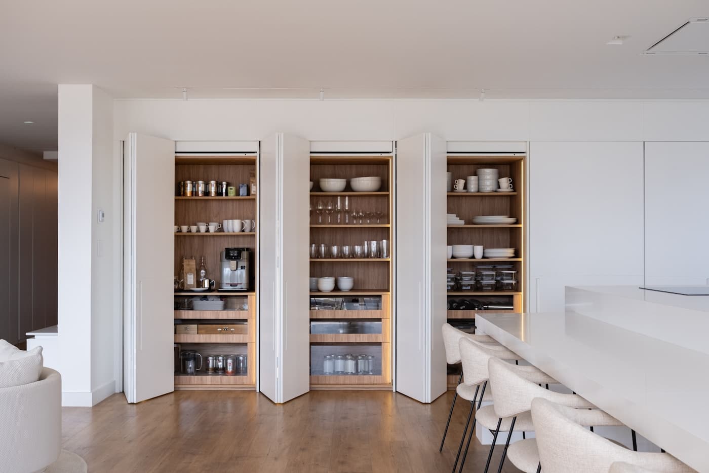 Organized pantry shelves with labeled jars and household staples